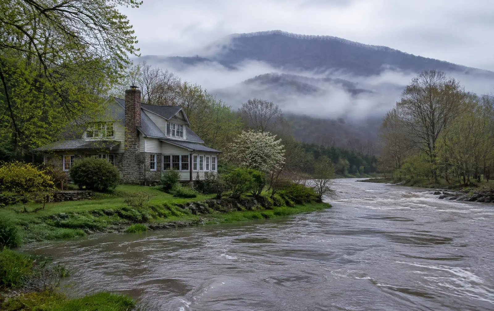 Home beside a creek with high water in Maybrook, NY — water, fire, and mold restoration service area