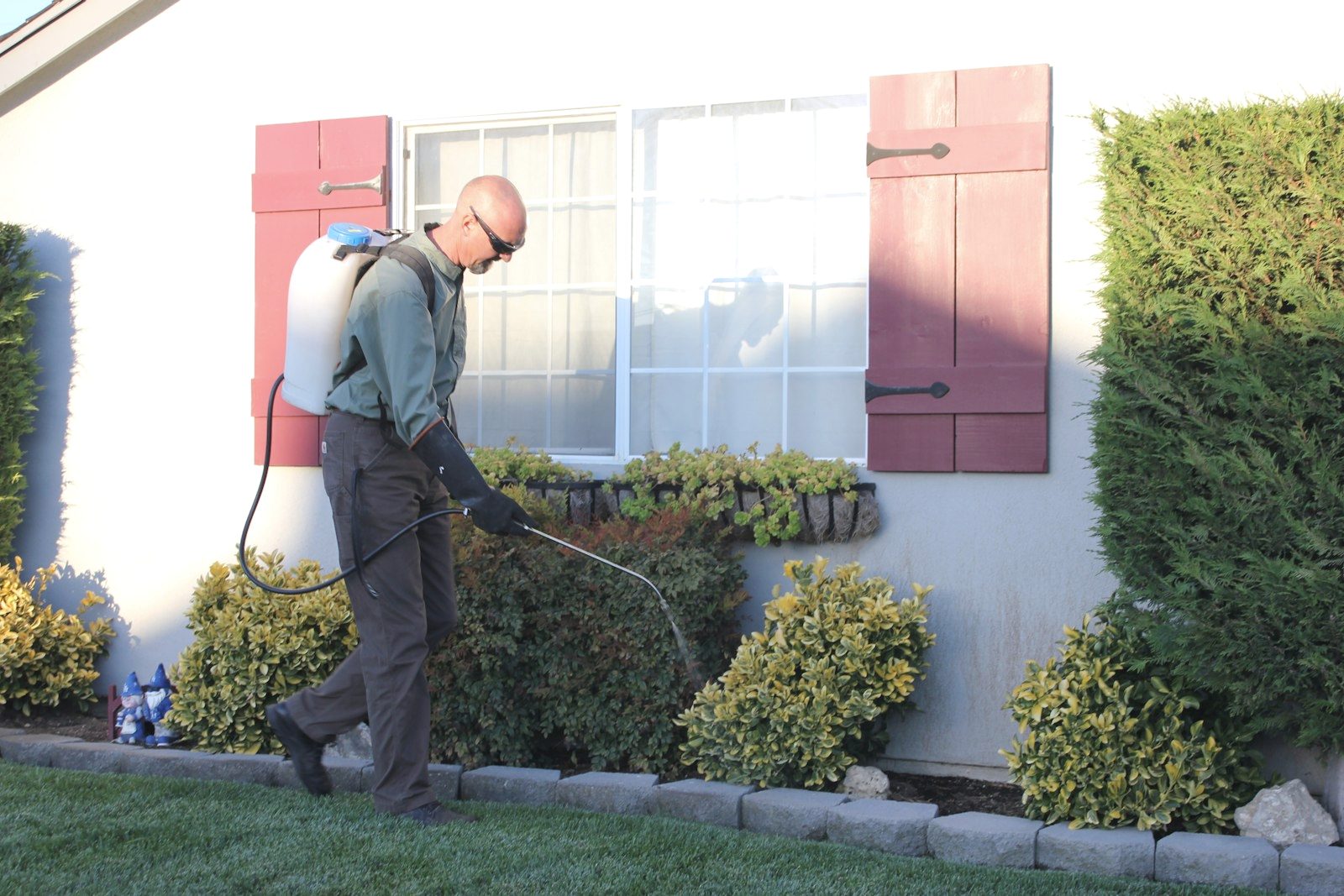NOFO technician inspecting the foundation sill line of an older Suffolk County home at dusk